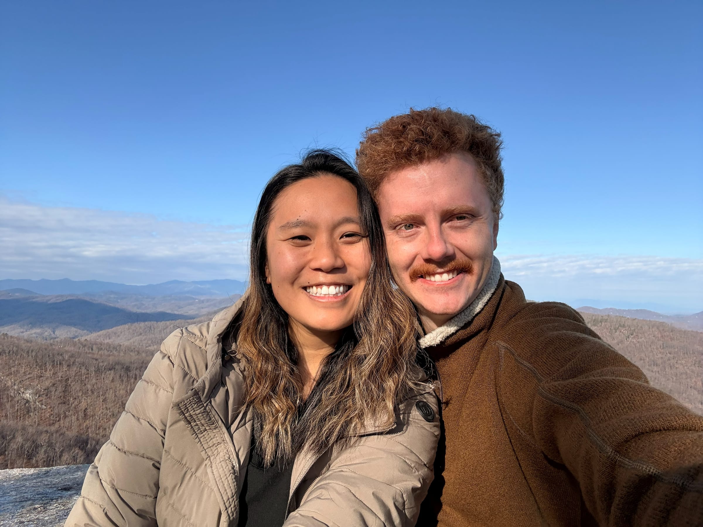 Jordan and her fiancé Dylan at a summit overlooking the Blue Ridge mountains