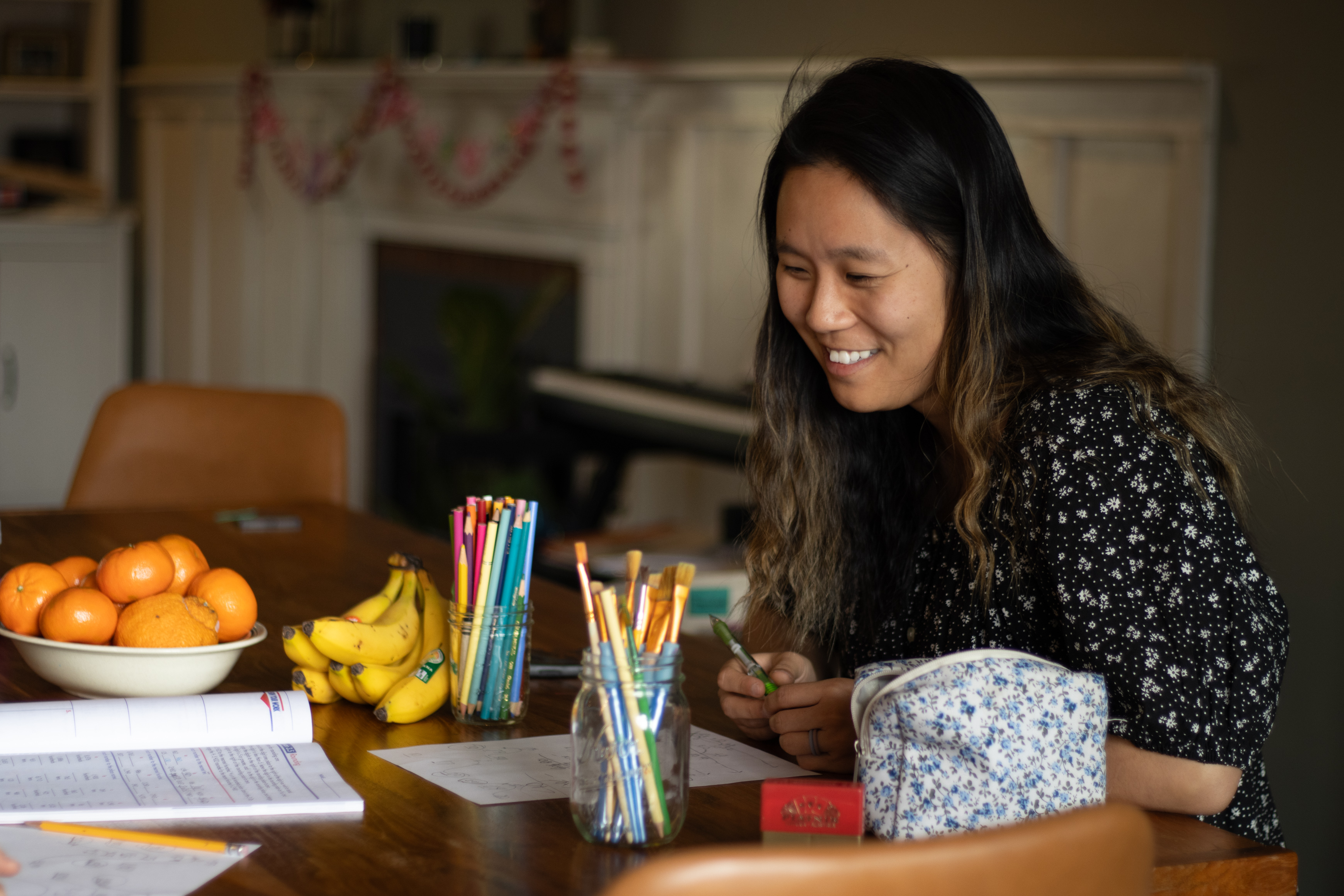 Jordan smiling while tutoring at a kitchen table